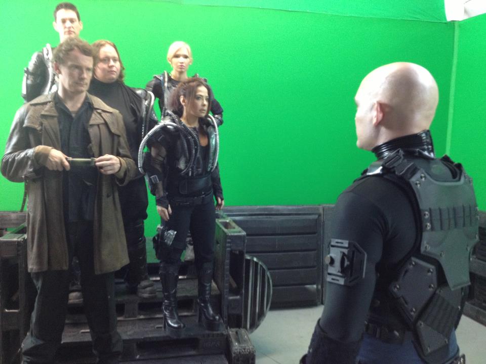 The cast of Starship: Rising in front of a green screen 